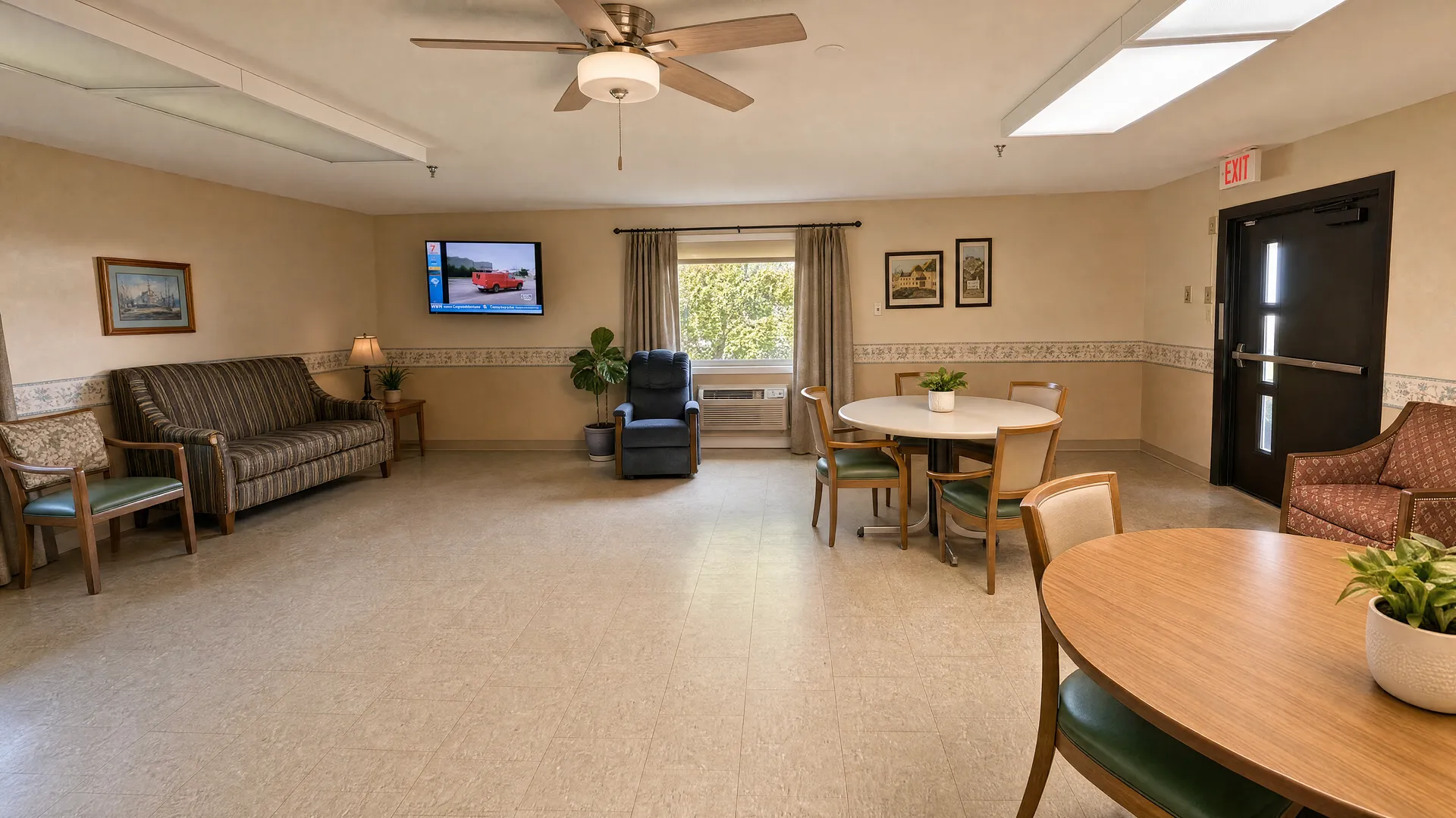 Common room with sofas, armchairs, television and tables at Rehabilitation Center of Independence