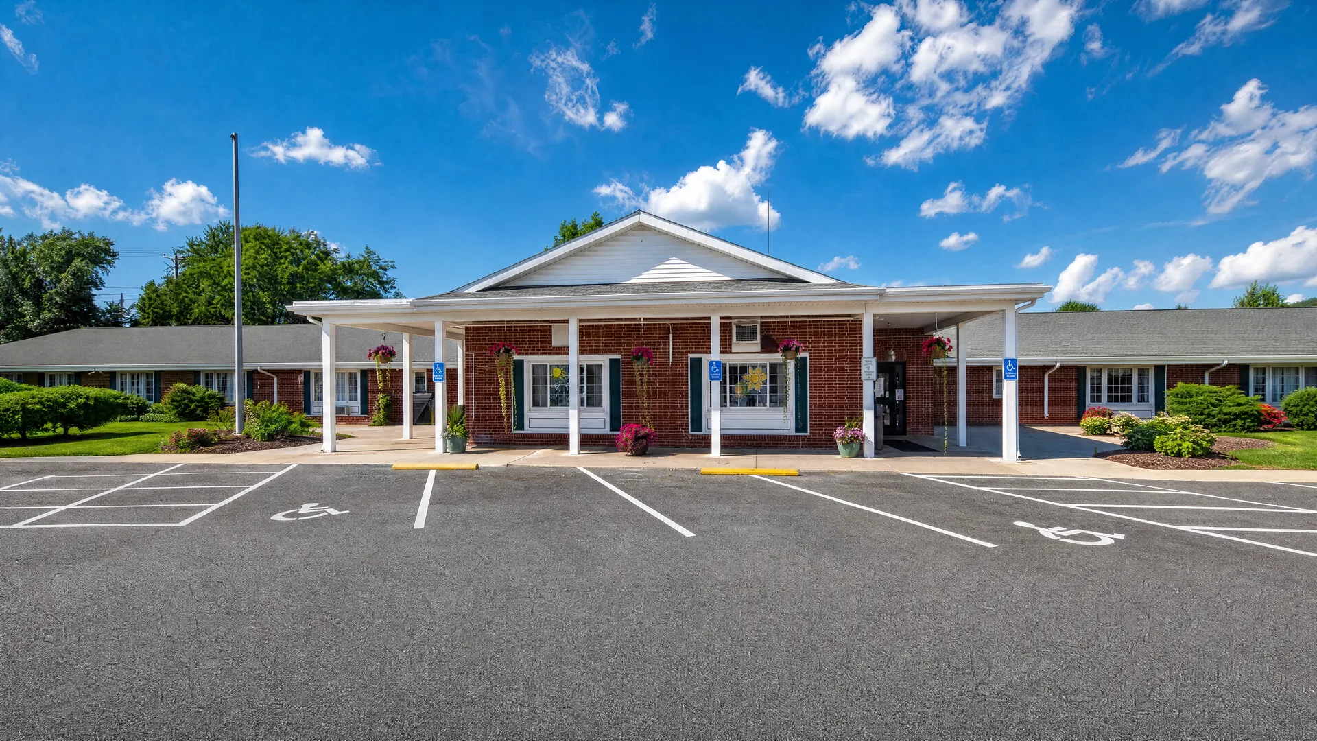 Front entrance of Rehabilitation Center of Independence with a covered portico and accessible parking