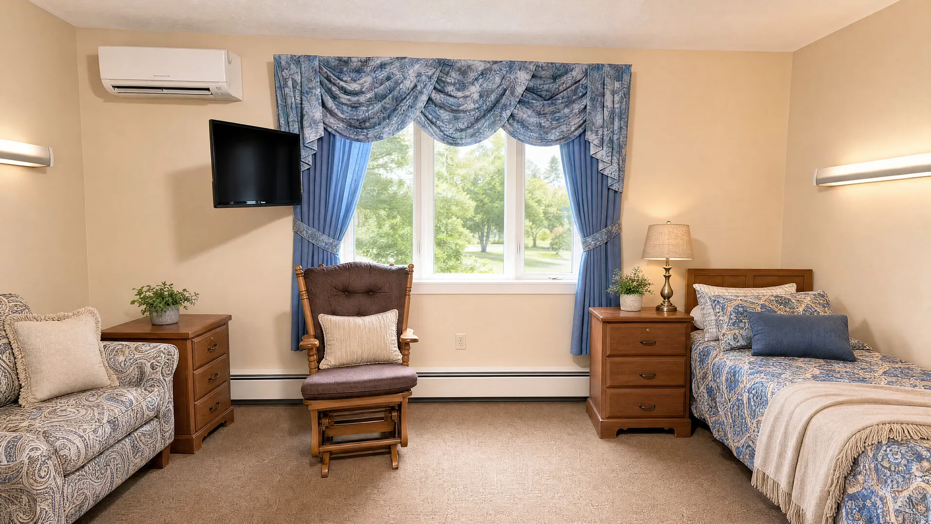 Private resident room with a bed, loveseat, armchair and television at Rehabilitation Center of Independence